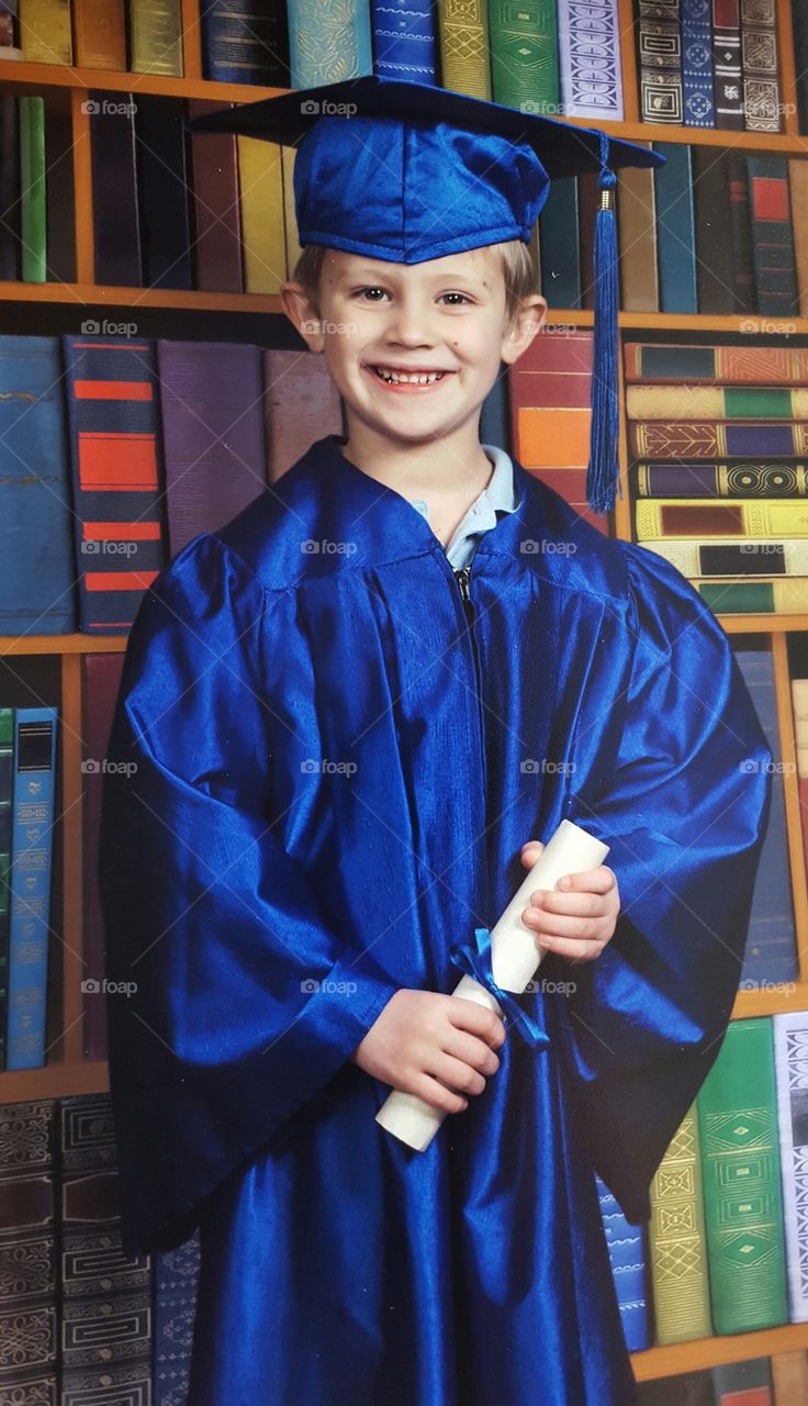 Portrait of a boy wearing graduation hat