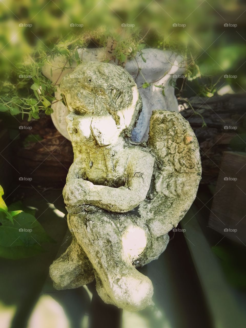 Old angel sculpture on a forgotten grave