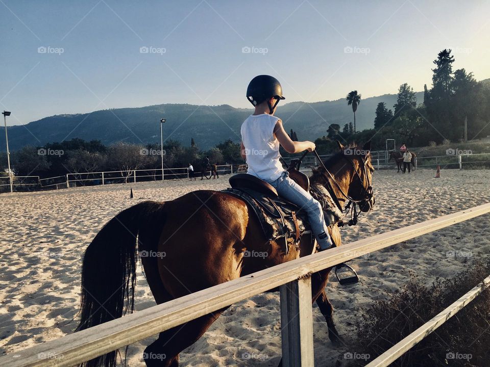 A boy rides into the sunset