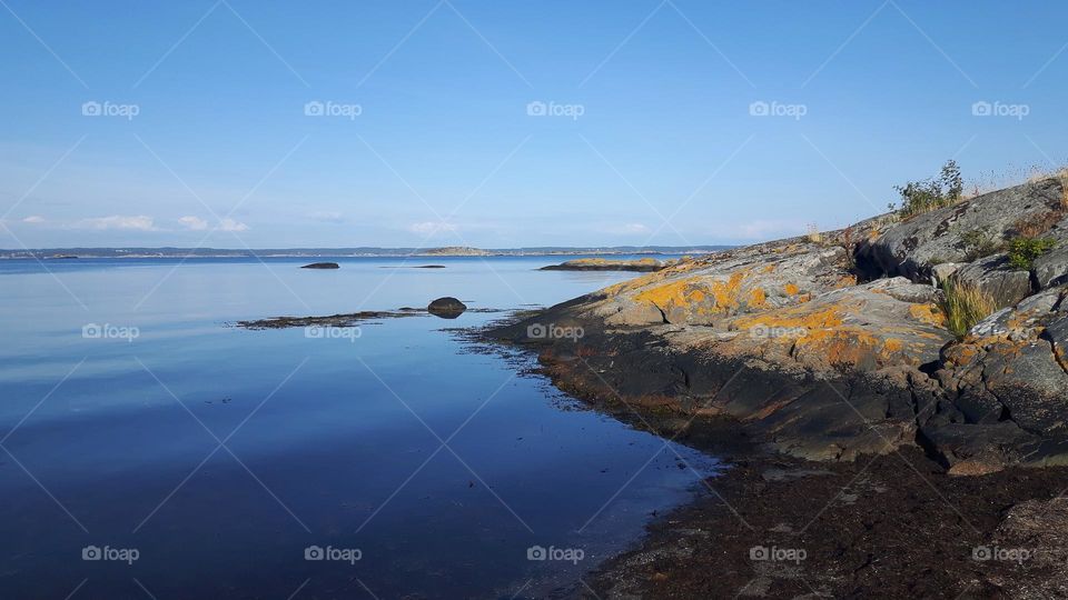 Calm blue Sea  and cliff meets sky