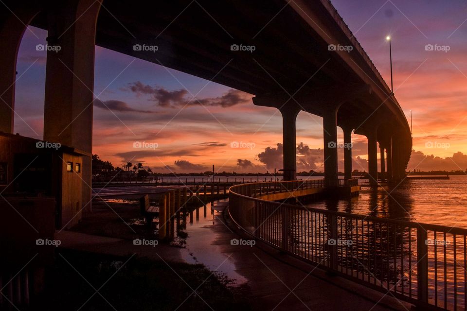 A view under the bridge looking toward the sky at sunset
