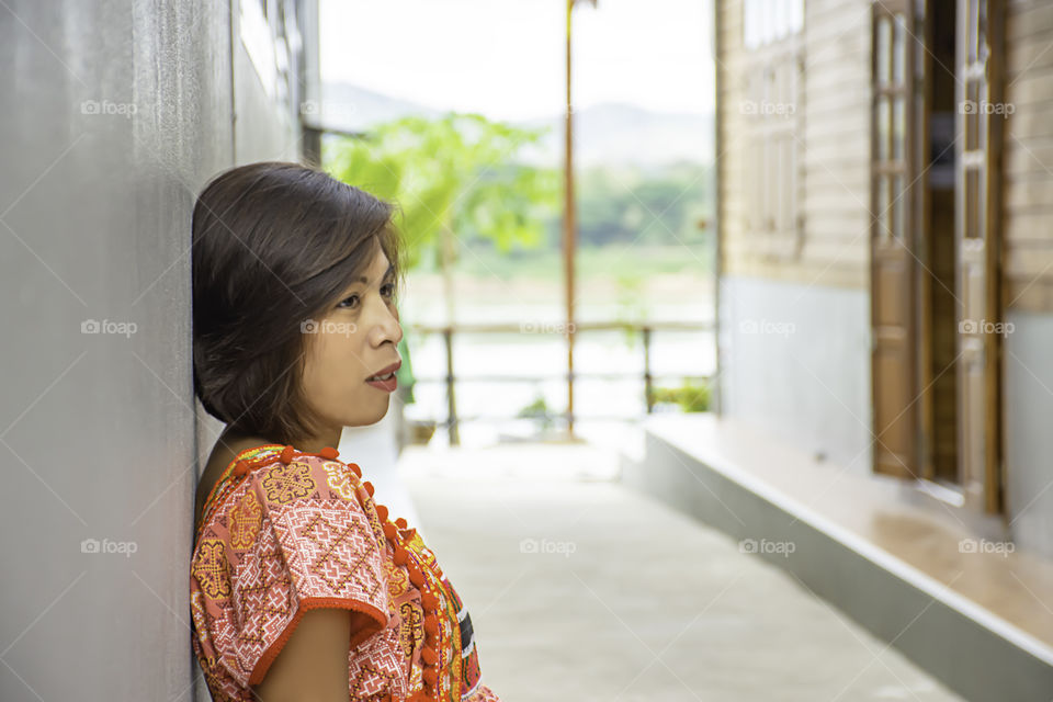 Portrait of Asean woman wearing a native of northern Thailand  background wooden wall.