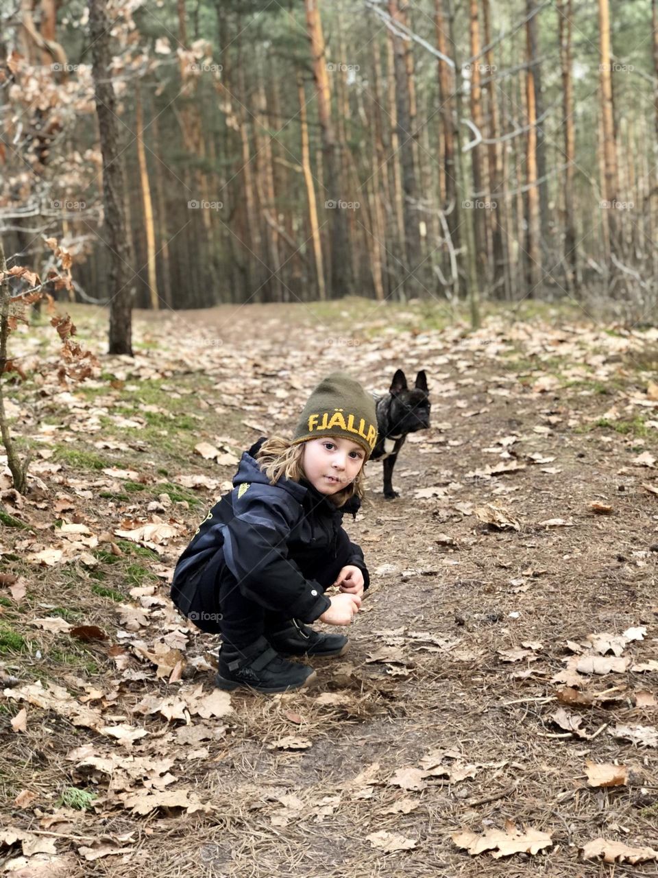Boy with a dog in a forest