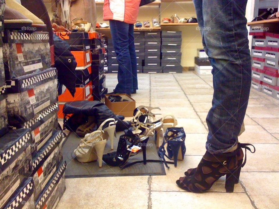 A girl trying shoes in shoeshop on