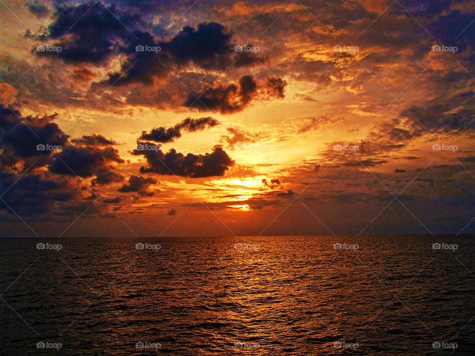sunset at the ocean beach. a stunning colorful sunset at the Atlantic Ocean while sailing
