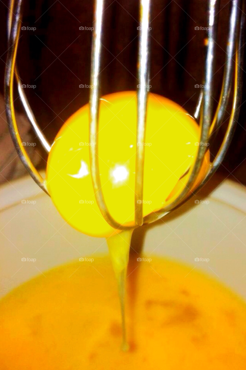 yellow egg whisk cradled by sellershot