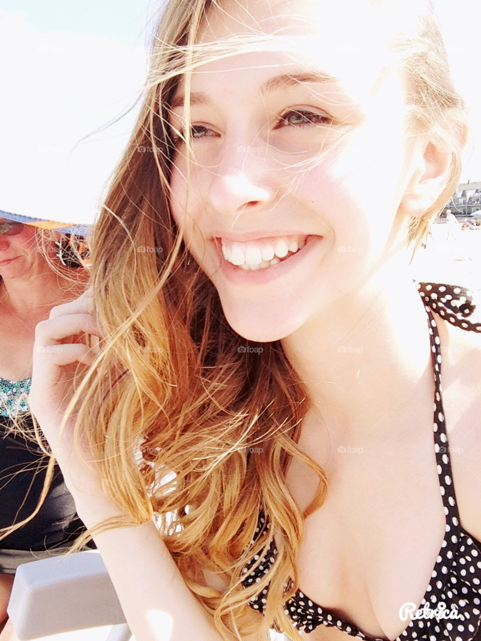 Summer smile, pretty girl sun soaked day at the beach