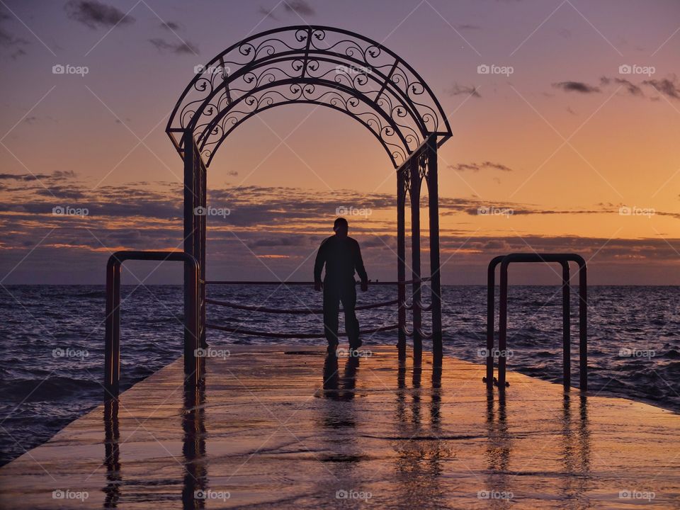 My colleague went on pier to enjoy a sunset. 