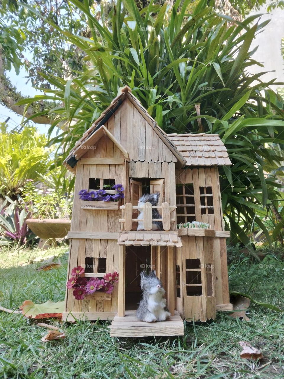Miniature house made of popsicle sticks (wood)