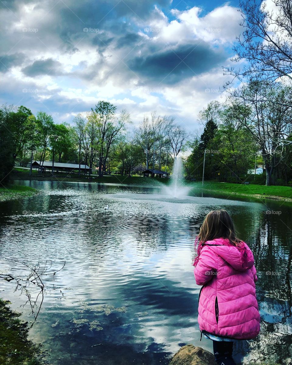 Little lady looking at the pond