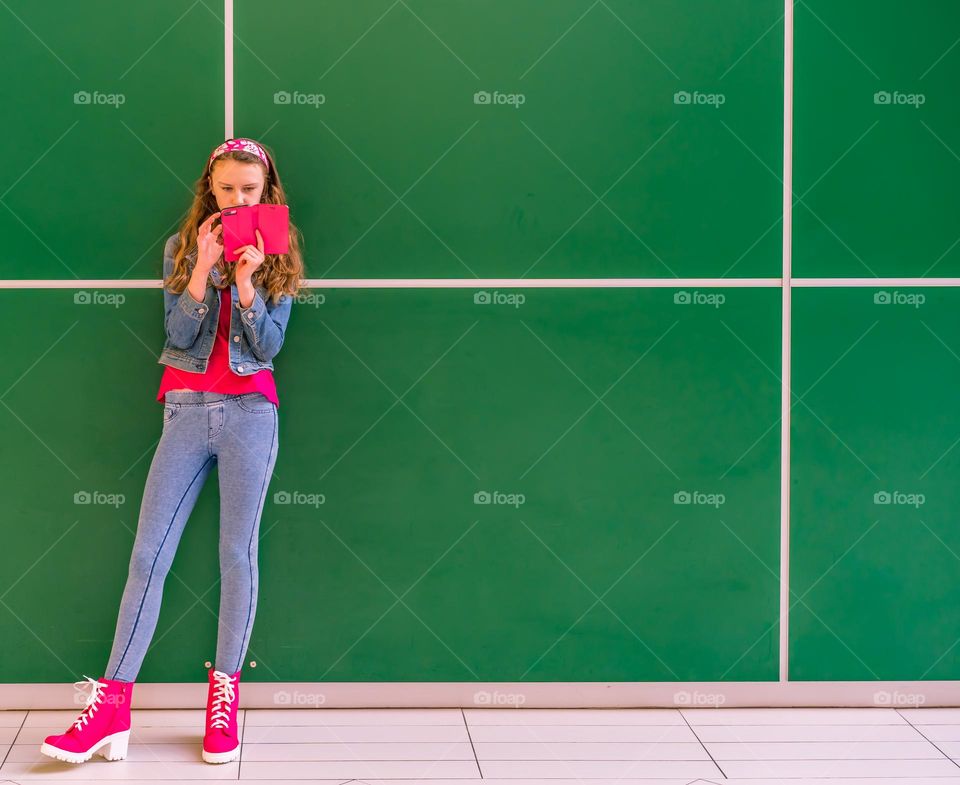 Girl looking at phone while posed