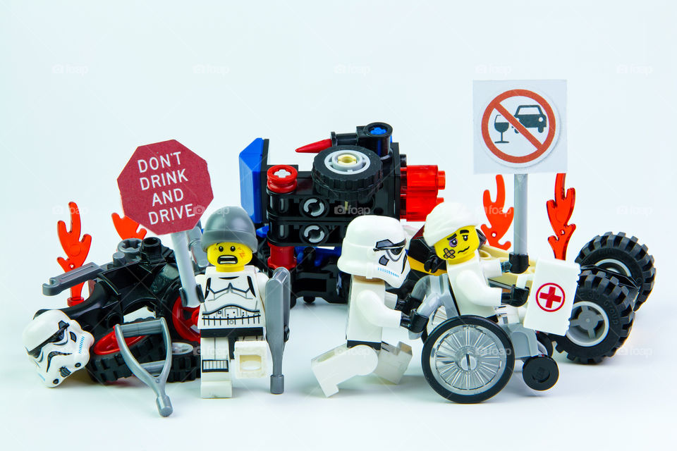 Lego star wars accident by a drunk driver. holding a sign Drink don't drive isolated on white background.Lego is an interlocking brick system collected around the world.