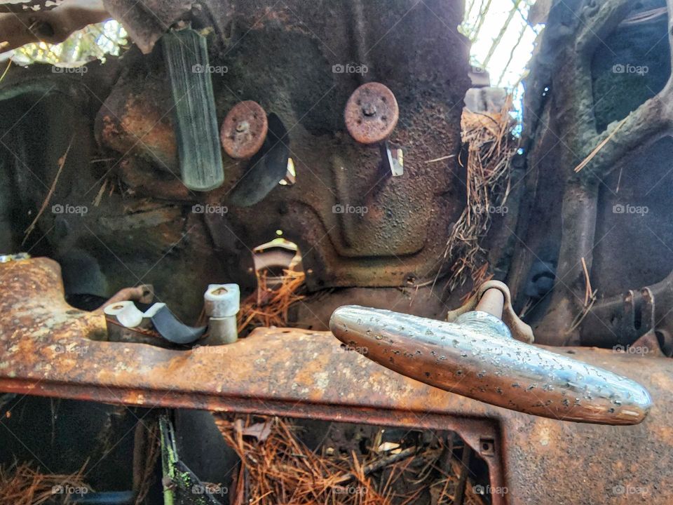 Metal frame of an old rusted vehicle.