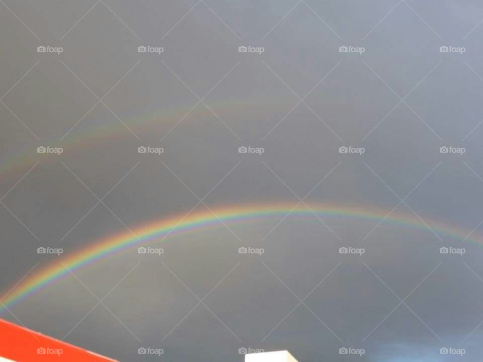Bright rainbow and faint double above.