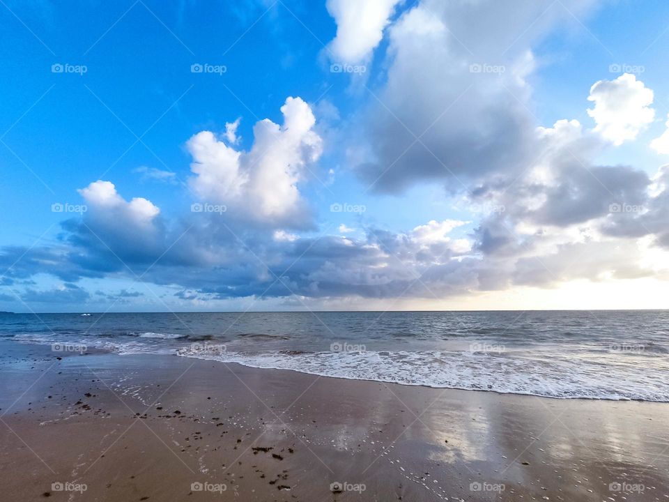 Atlantic Ocean, Brazilian province, sand, waves, horizon line, white clouds and the blue sky