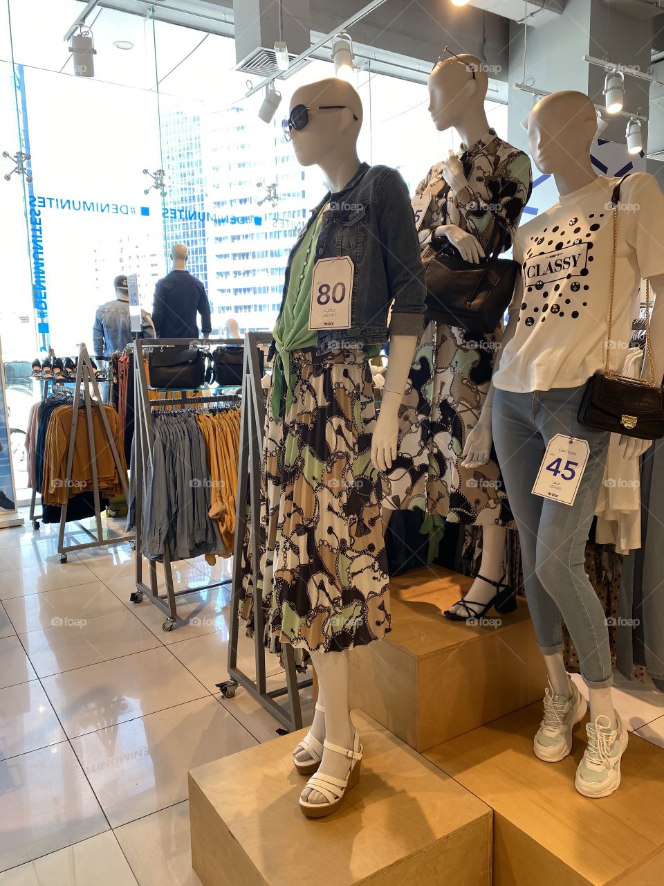 Ladies dress shopping center, photography of a dress shop with displaying variety of dresses in different colors with price tags