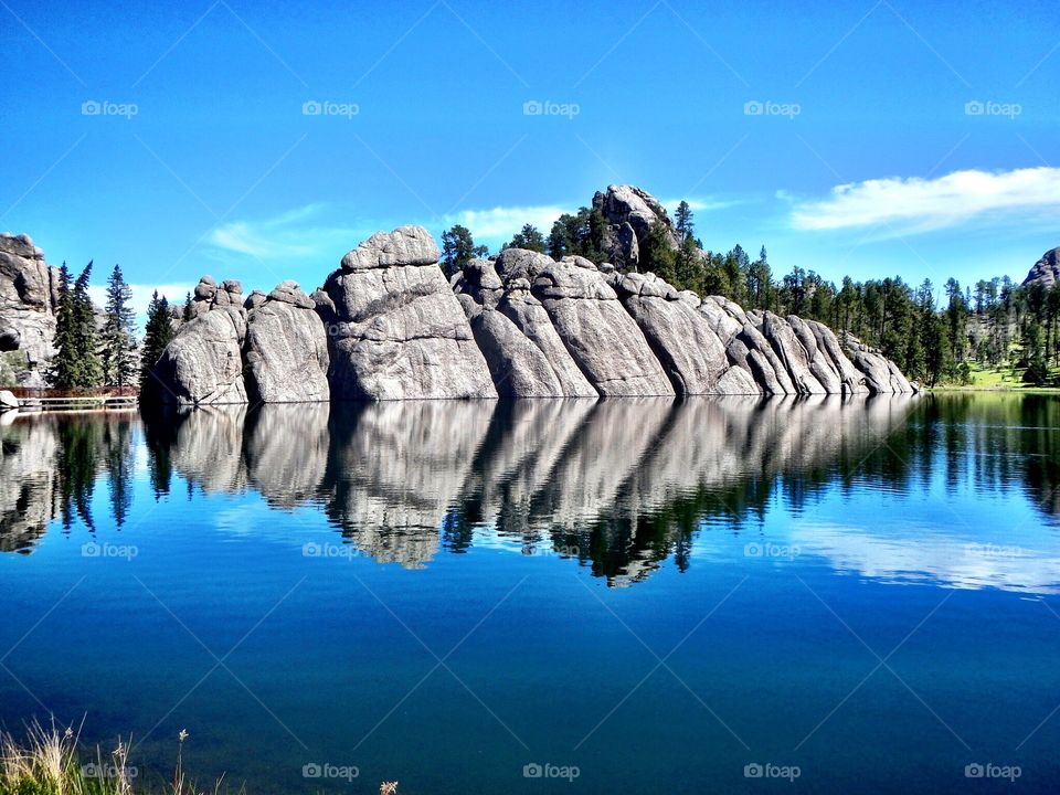 Reflection of boulder in lake