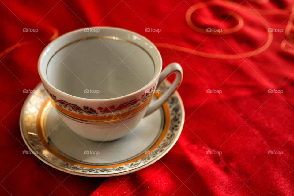 Empty tea cup on tablecloth