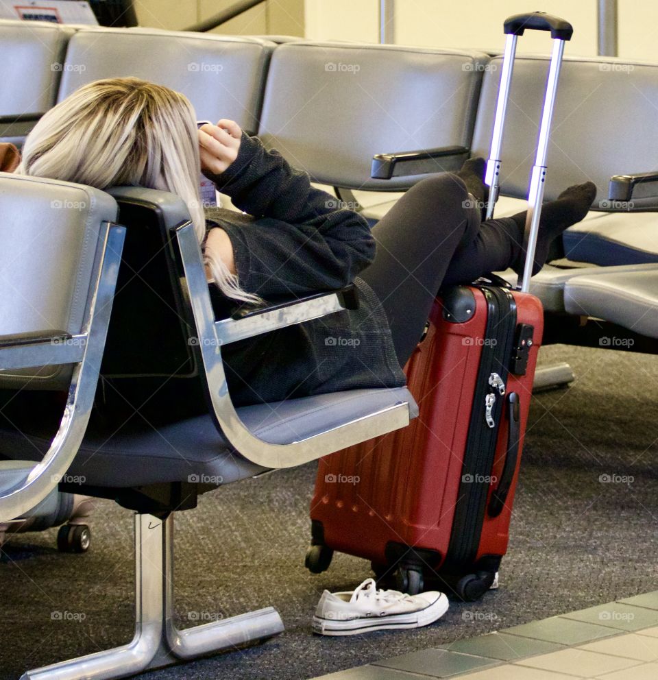 Weary traveler resting in an airport