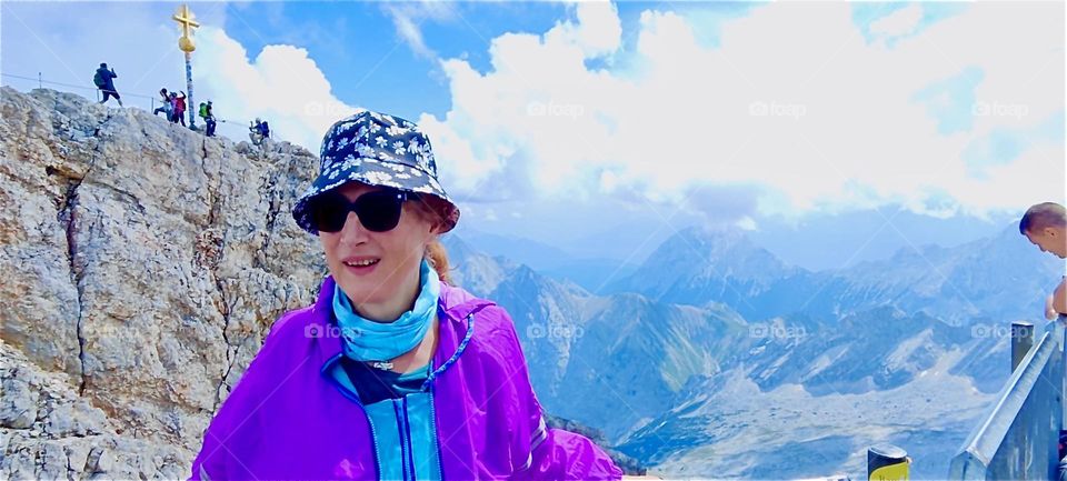 Altitude can bring with it incredible joy and an elation of the senses as we see in our lady on the “Zugspitze” plateau reached by aerial tramway right below the summit at 2692 m, the tallest mountain in the German “Alps”. 2024. Hypnotic Productions