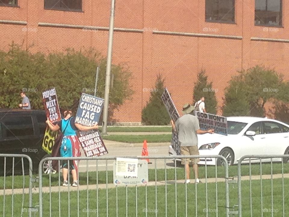 Westboro Baptist church members holding signs to protest an LGB club formed by students of IUPUI.
