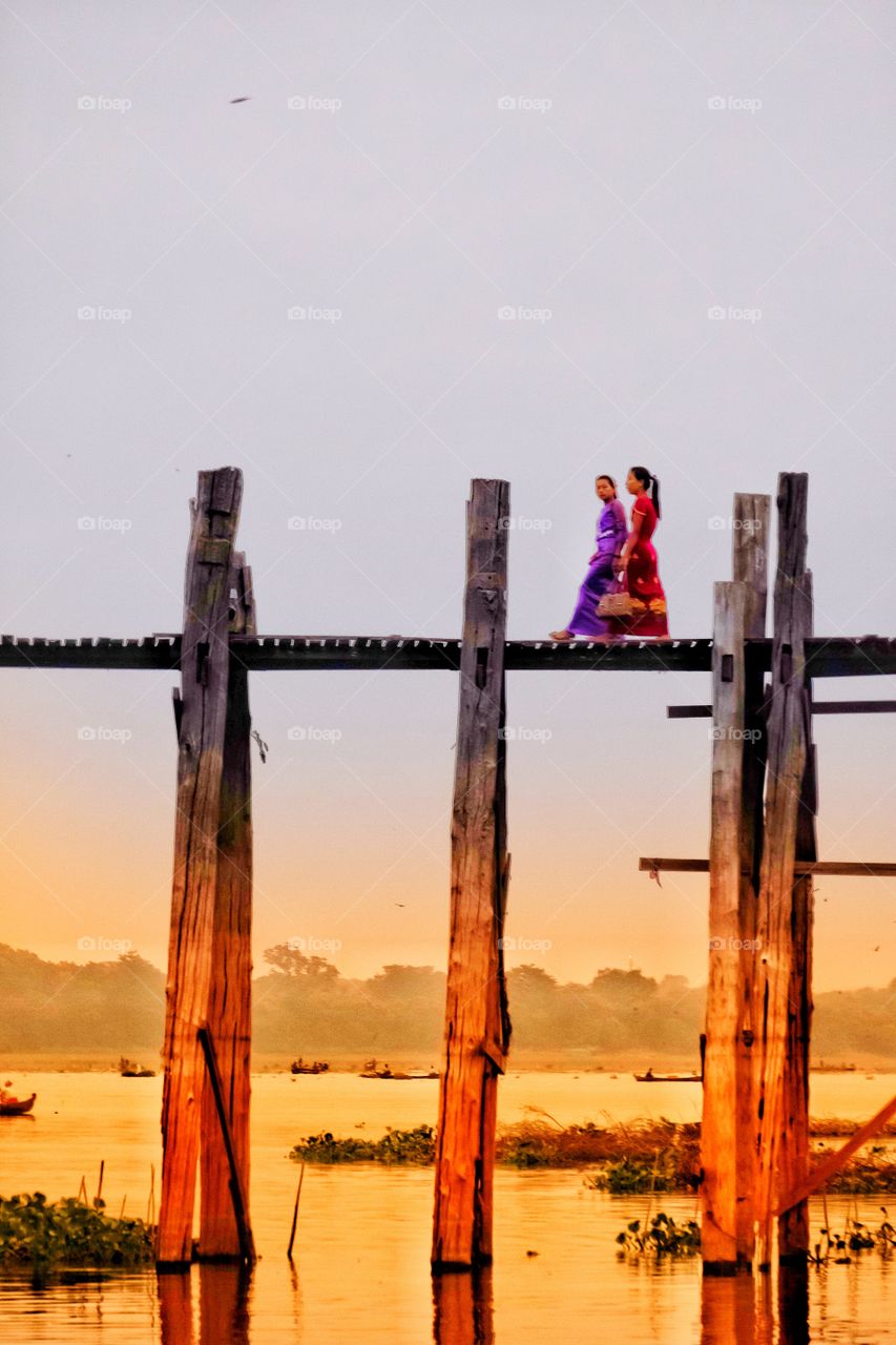 Local people are walking on U Bein the longest wooden bridge in the world to go to morning market,Mandalay Myanmar 