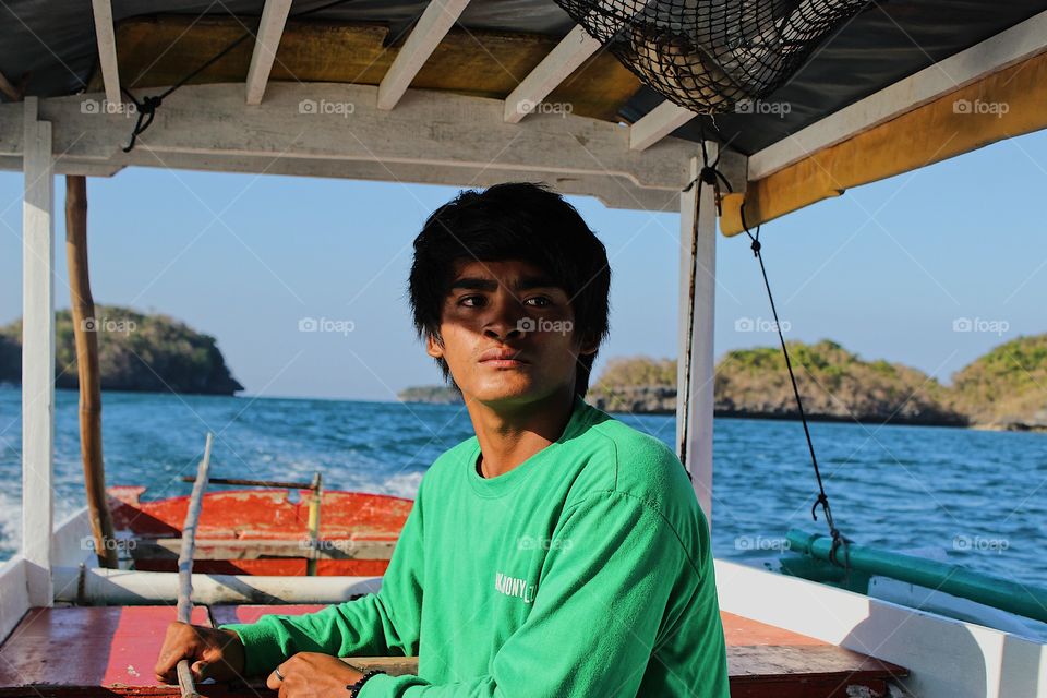 A Filipino boatsman focusing on the horizon