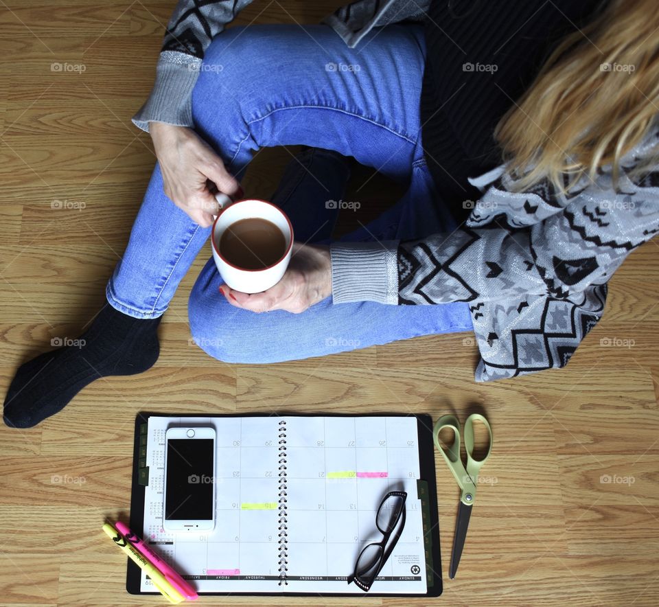Woman drinking coffee as she plans her day