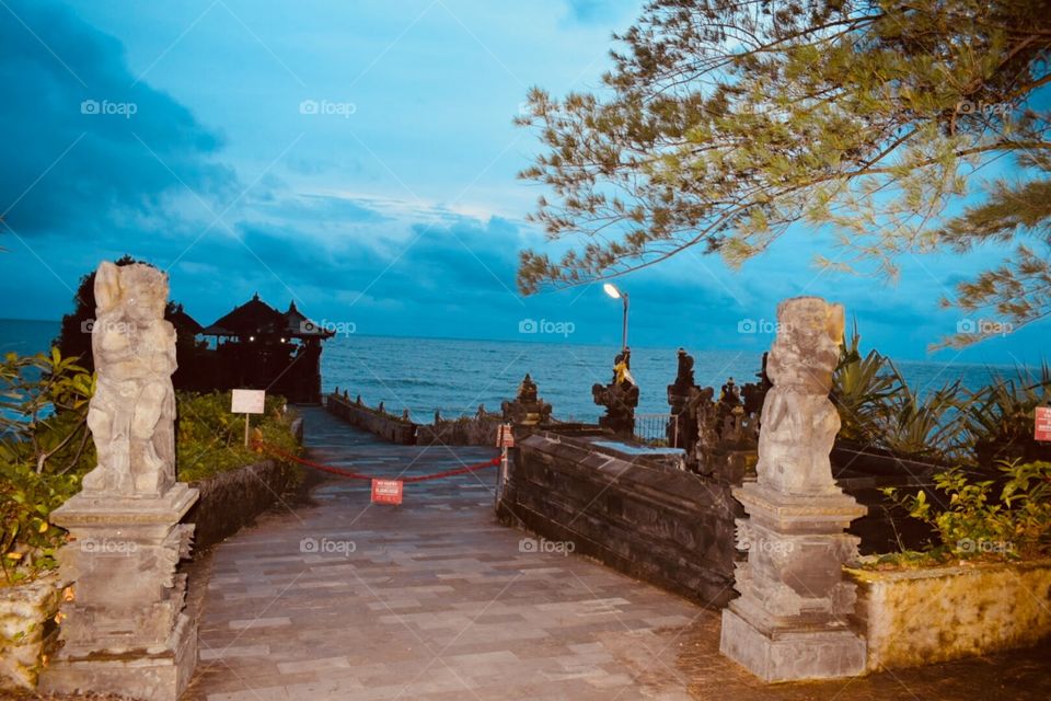 Tanah Lot Temple at Bali, Indonasia. This is the Famous Tourist spot where thousands of Tourist Gather to see the Amazing Sunset! A world famous Sunset Point.