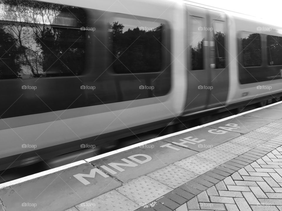B&W moving train through Berkhamsted Station ... Mind The Gap ... herringbone platform 