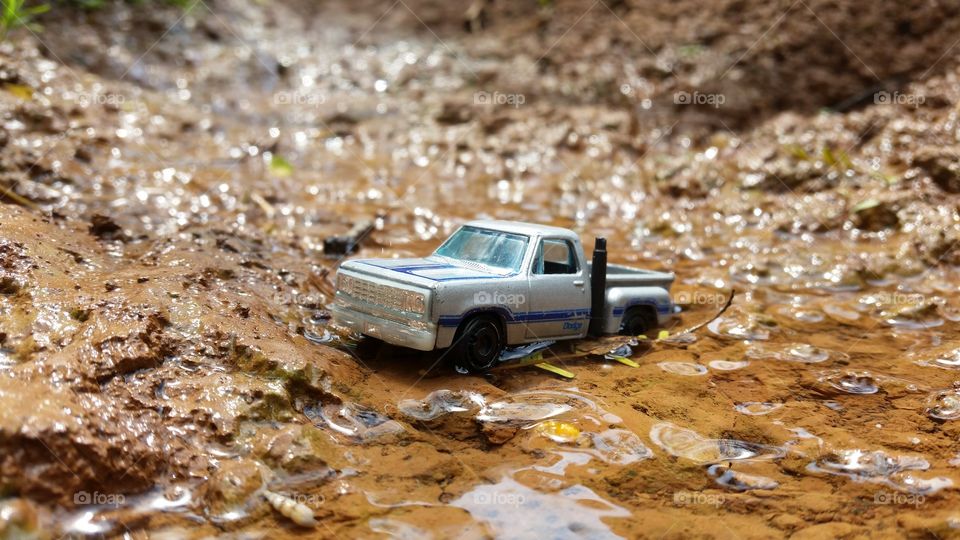 miniature photo of a car crossing a river