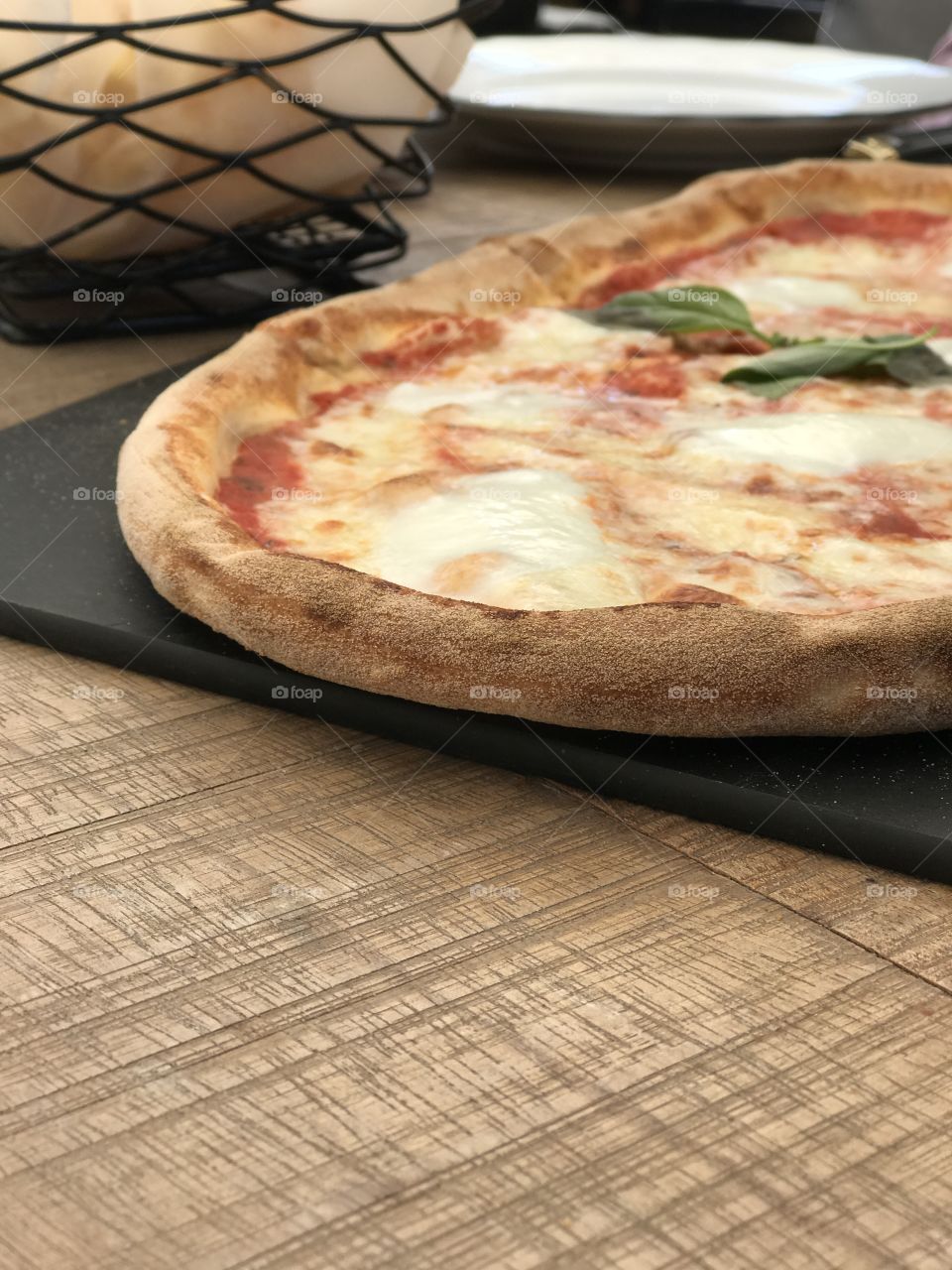 Fresh Italian pizza on a wood table. Delicious Pizza Margherita
