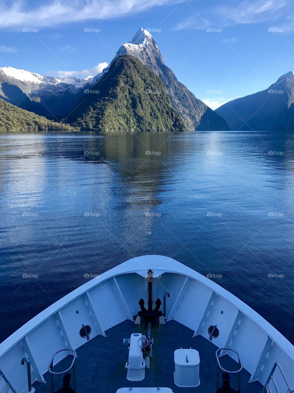 Ship sailing through Milford Sound towards Mitre Peak, New Zealand 