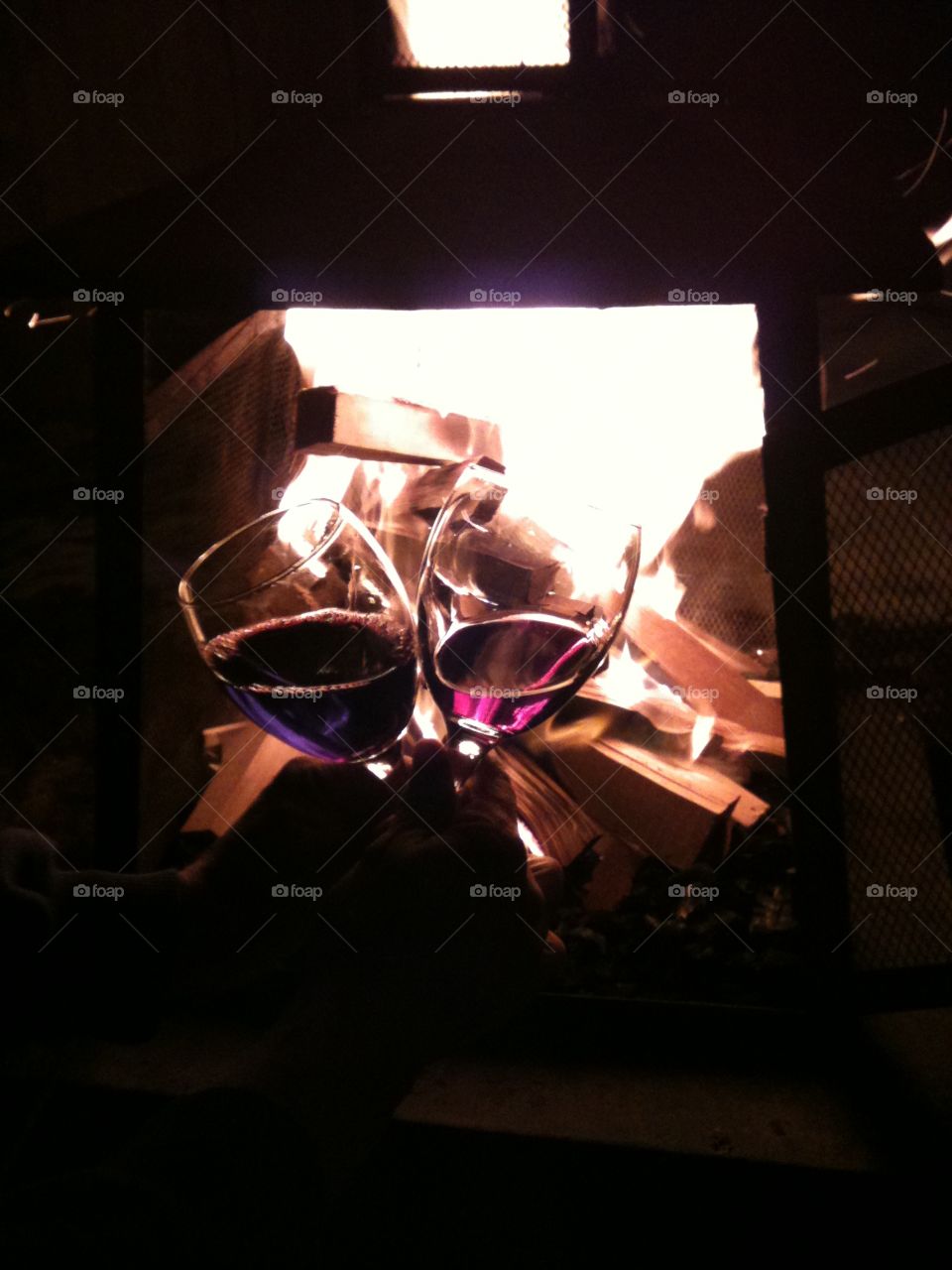 Wine glasses in front of fire