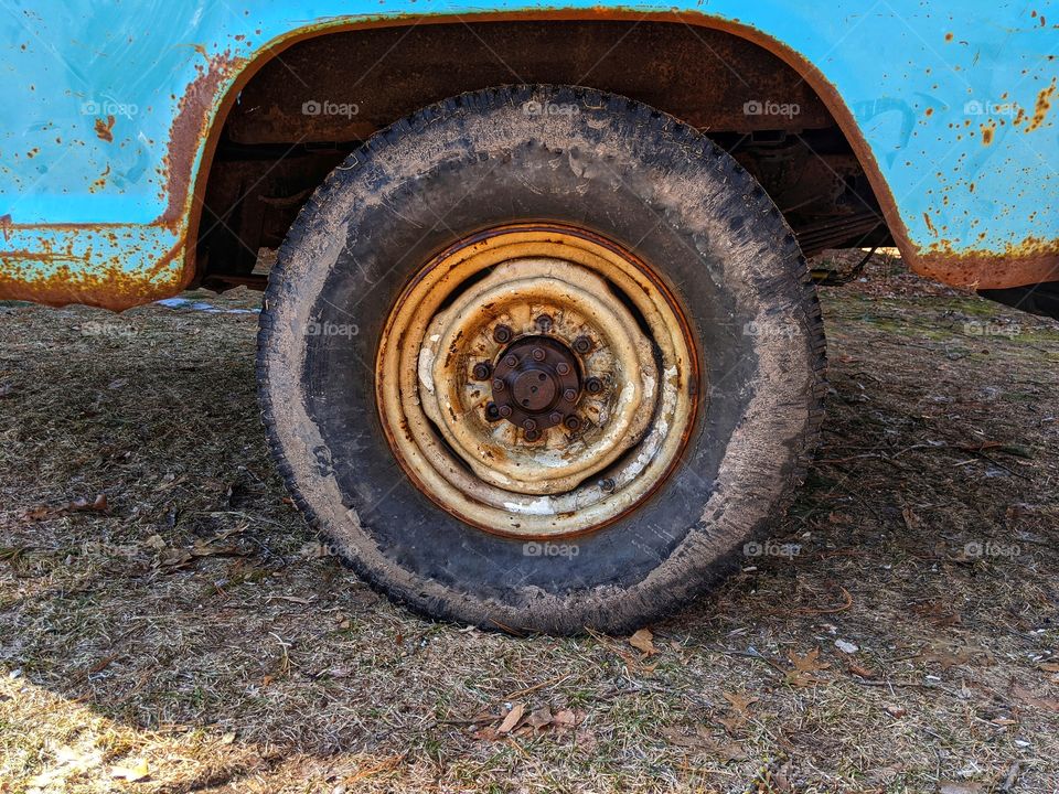 Vintage muddy truck tire on the ground