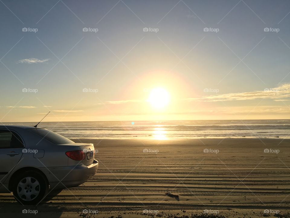 My corolla on the beach at sunset