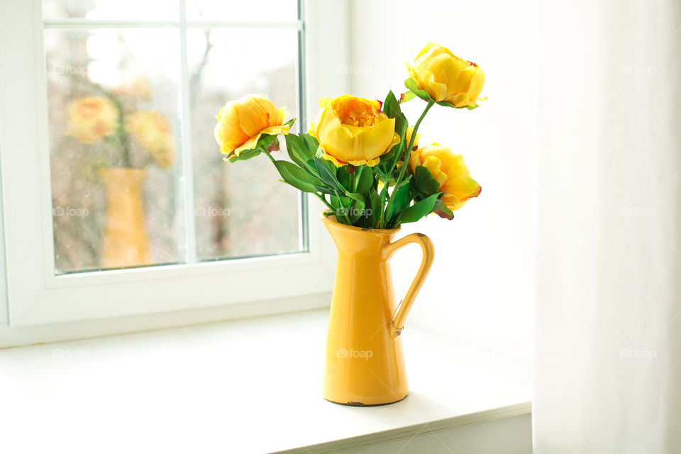 Close-up of flower pot on window sill