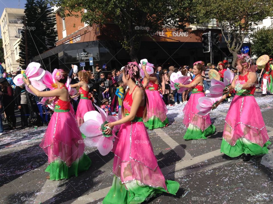 Women dressed as flowers in carnival parade.