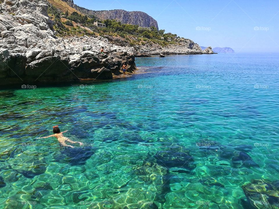 girl is snorkeling in Sicily