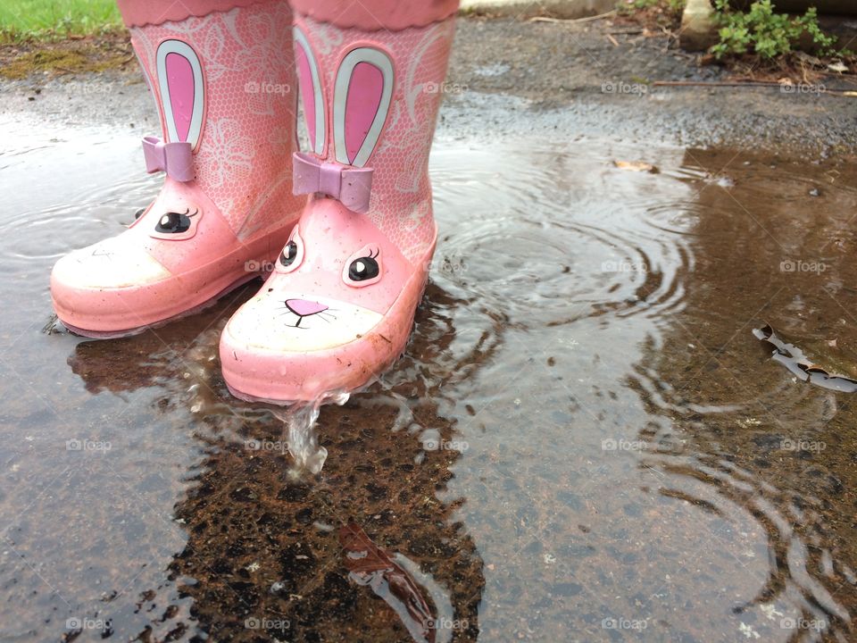 Girl playing in a puddle 
