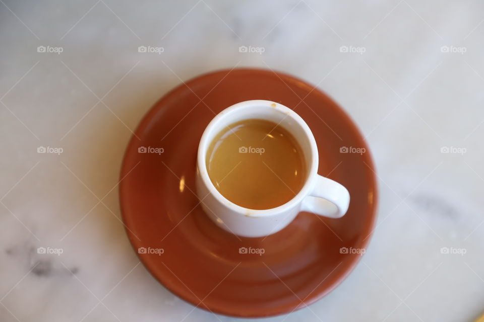 Cup of coffee laying on top of table