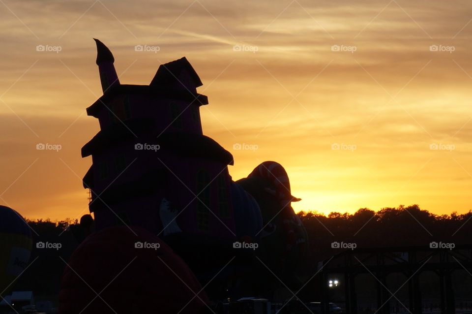 Haunted house hot air balloon silhouette at sunset