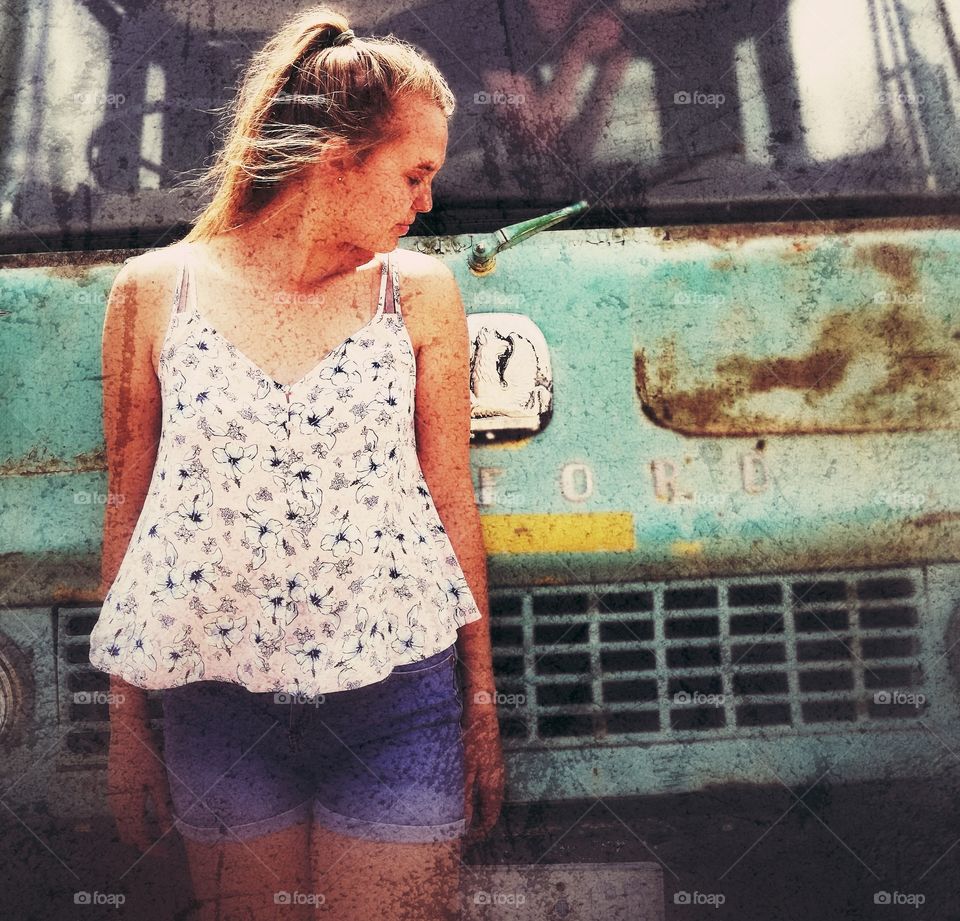 Girl standing infront ofold vintage  ford truck