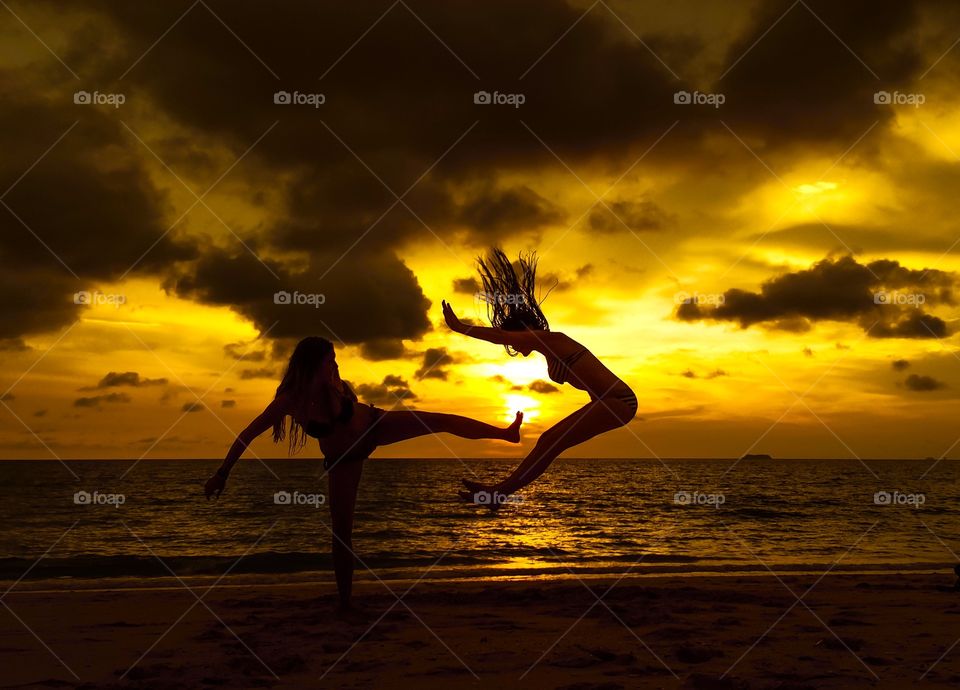 Sunset fun! 😊. Girls having fun at golden hour, sunset at tropical beach in Thailand