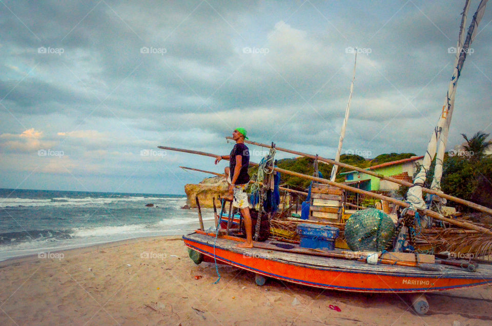 Canoa quebrada beach with fishing boats with man 