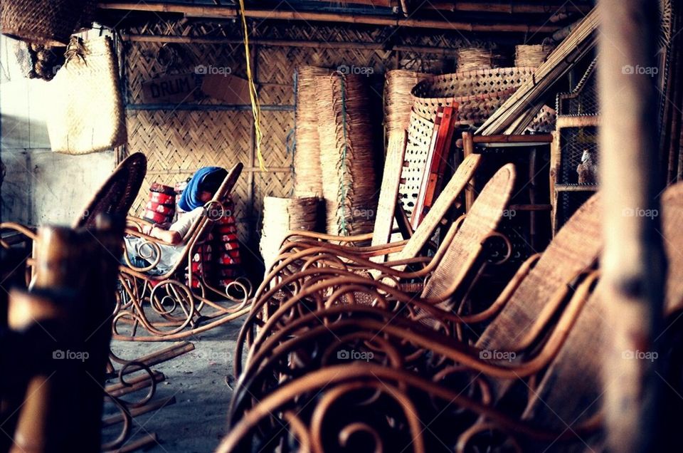 A seat maker rests in one of his creations