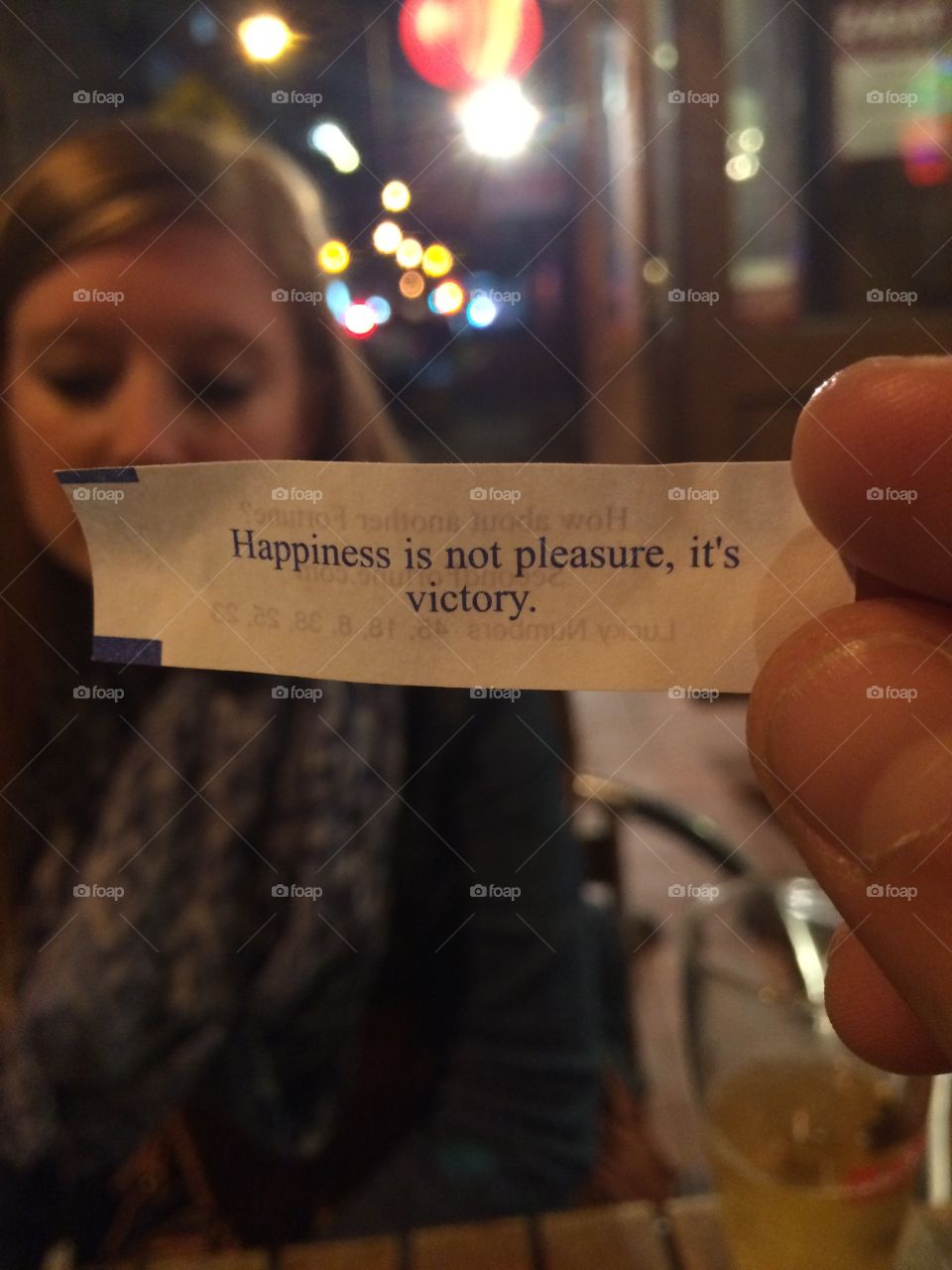 Happiness is not pleasure, it’s victory! Fortune cookie at a Chinese restaurant in New York City.