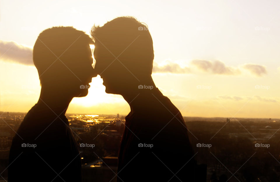 SUNSET MEN KISSING
