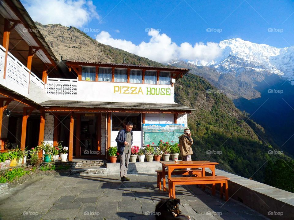 Pizza with a Himalayan view. We could see Annapurna South and Huinchuli from this lodge. Photo taken on the Annapurna Base Camp Trek in Nepal.