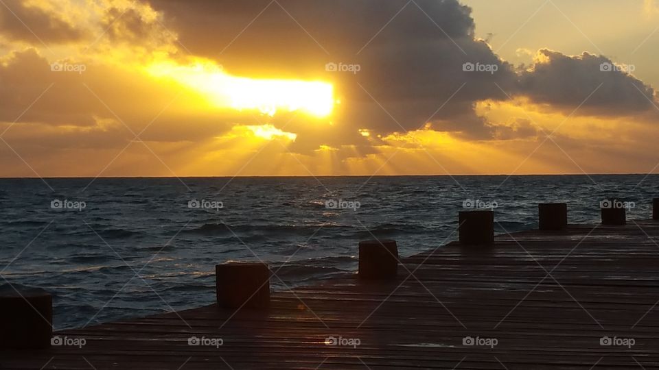 ocean sunrise with dock